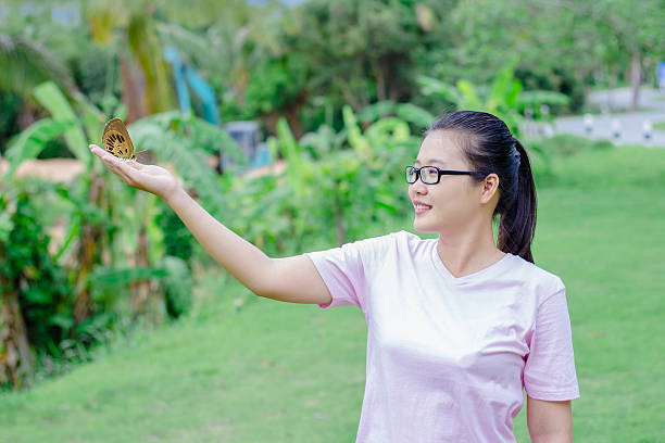 istock Woman playing with a butterfly 547030876