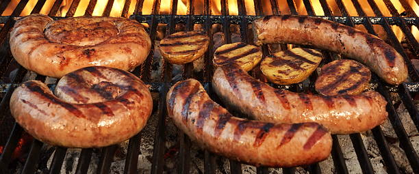 istock Grilling German Sausages On Hot Barbecue Charcoal Grill. 547032426