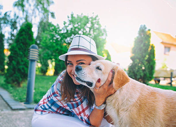 istock Woman embracing her dog in  park 547035636