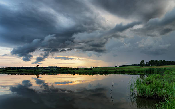 istock Dramatic summer sunset at the lake with dark clouds 547037044