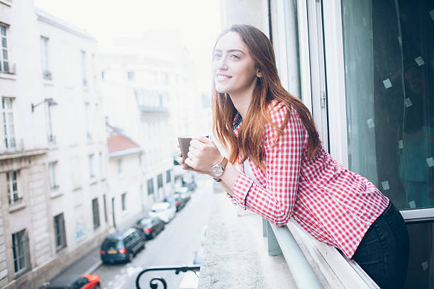 istock Cheerful young woman drinking coffee 547039136