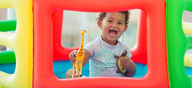 Kid having fun in inflatable swimming pool.