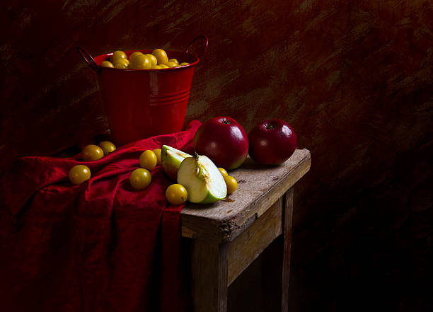 Still life with fruit apples and plums mirabelle