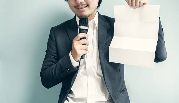 istock Asian man holding white paper 547041262