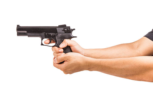 istock Black pistol in a hand on white background 547041382