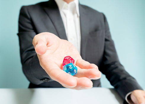 Asian businessman holding dices.