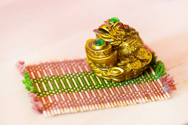 Chinese Feng Shui money frog for good luck and wealth Chinese Feng Shui lucky money frog for good luck and wealth, on bamboo mat chinese frog stock pictures, royalty-free photos & images