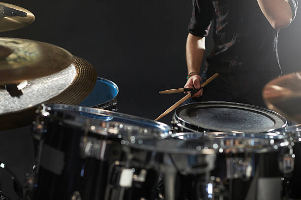 istock Close Up Of Drummer Playing Drum Kit In Studio 547044042