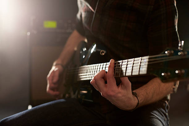 istock Close Up Of Man Playing Electric Guitar In Studio 547044188