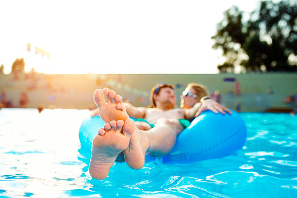 istock Couple in inflatable ring in pool. Summer and water. 547045776
