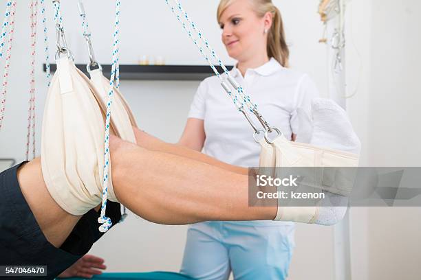 Physiotherapist With Patient On Sling Table Stock Photo - Download Image Now - Adult, Business Finance and Industry, Chiropractor