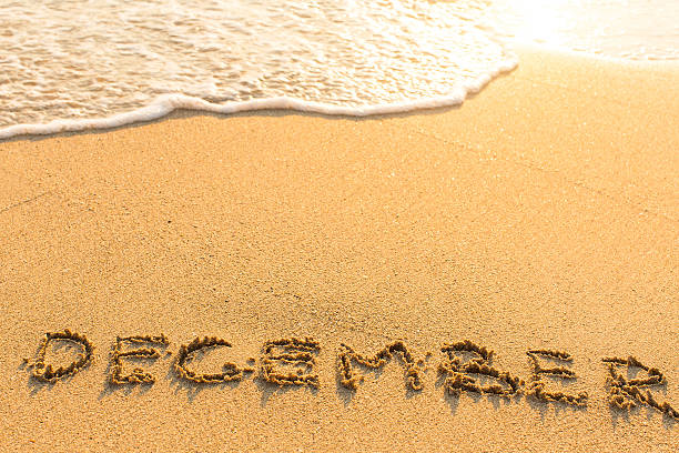 istock December - drawn by hand on a sandy sea beach. 547046622