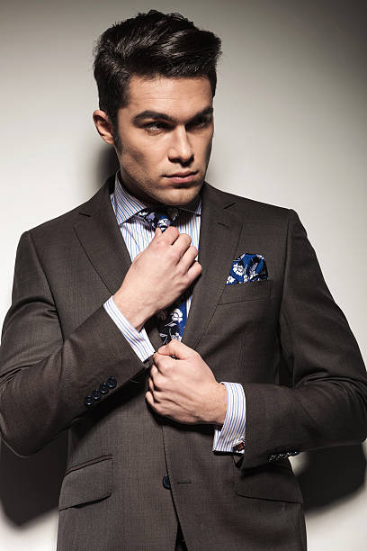istock young business man fixing his tie 547046980
