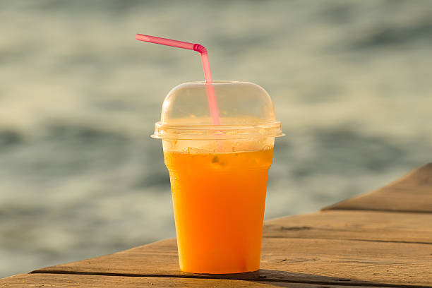 istock Fresh orange juice against the blurred sea. 547047266