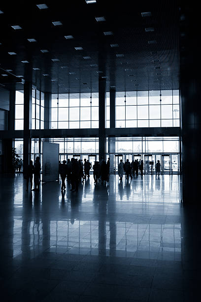 istock Silhouettes of people in modern hall 547047840