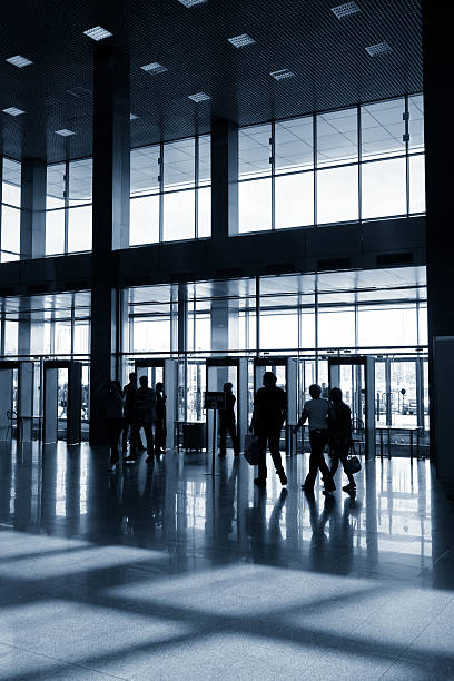 istock Silhouettes of people in modern hall 547048036
