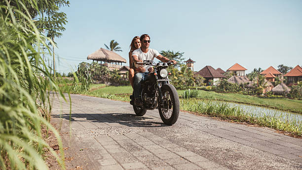istock Young couple riding motorcycle on rural road 547048372