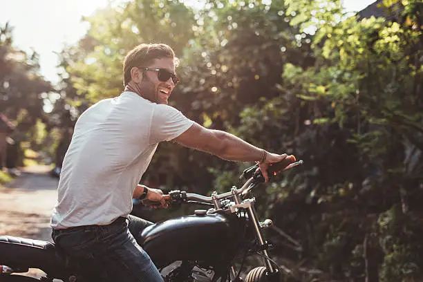 Photo of Handsome young man on motorcycle