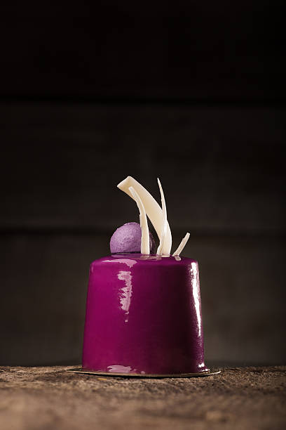 istock Deep purple cupcake on the wooden table 547049298