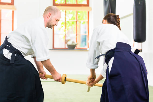 istock Man and woman having Aikido sword fight 547049770