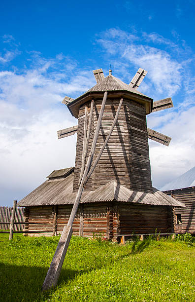 istock Wooden windmill on cloudy sky background 547049916