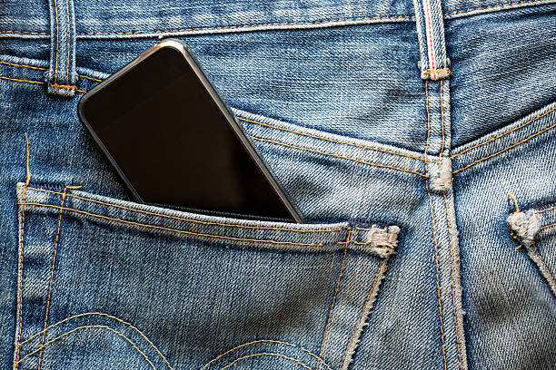 istock Mobile phone in back pocket faded jeans 547049918