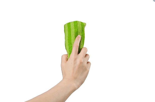 istock right hand holding green wipes. 547050820