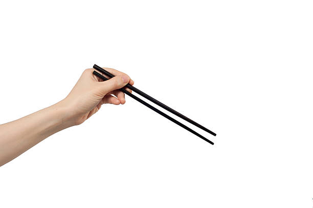 left hand holding chopsticks. left hand holding chopsticks on white background. left handed catcher stock pictures, royalty-free photos & images
