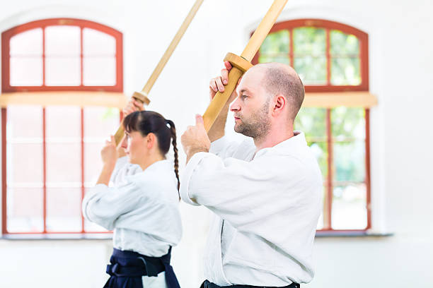 istock Man and woman having Aikido sword fight 547051054