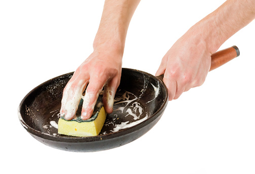 Men hand wash with a sponge pan .
