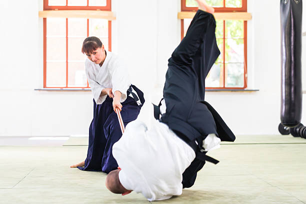 istock Man and woman having Aikido stick fight 547051224