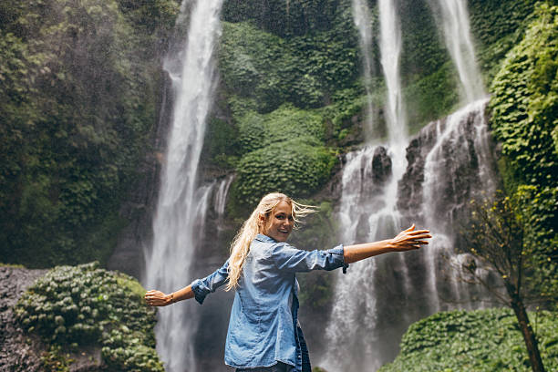 istock Tourist enjoying by a waterfall in forest 547051294