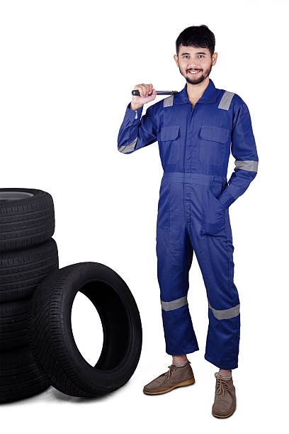 istock Young mechanic with tires and tool 547053092