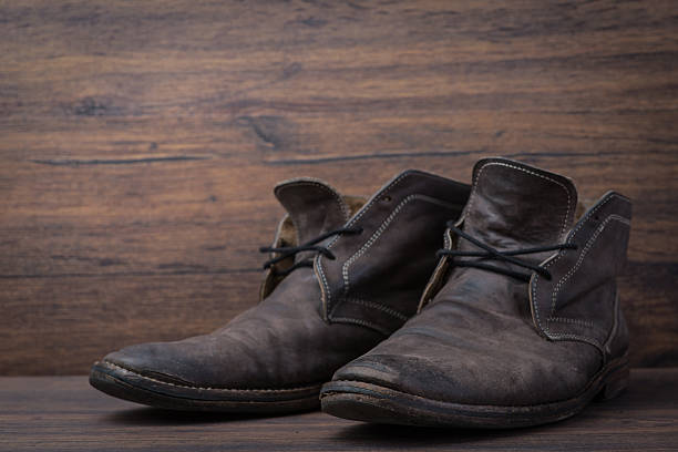 istock Old worn out brown leather shoes over the dark background 547055154