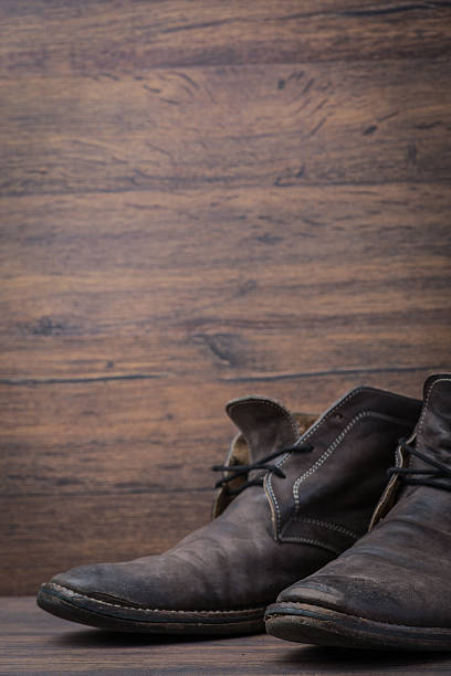istock Old worn out brown leather shoes over the dark background 547055382