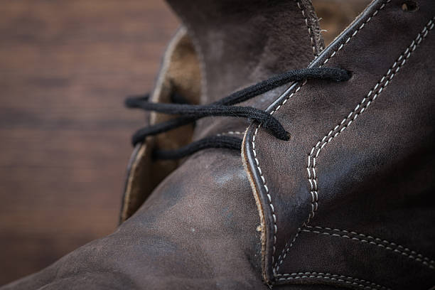 istock Old worn out brown leather shoes over the dark background 547055452
