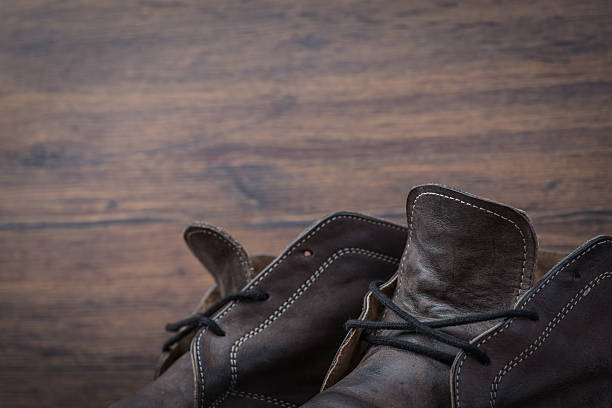 istock Old worn out brown leather shoes over the dark background 547055610