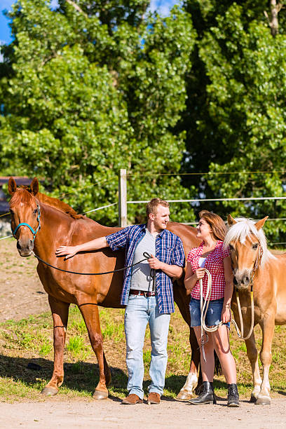 istock Couple petting horse on pony stable 547056640