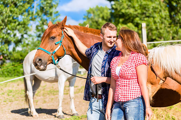istock Couple petting horse on pony stable 547056710