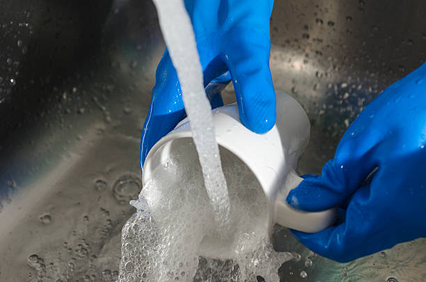 istock woman hands rinsing a glass. 547056988