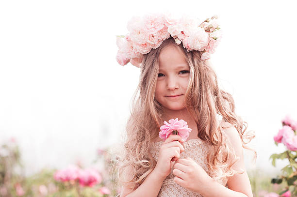 istock Smiling kid girl with flowers 547057348