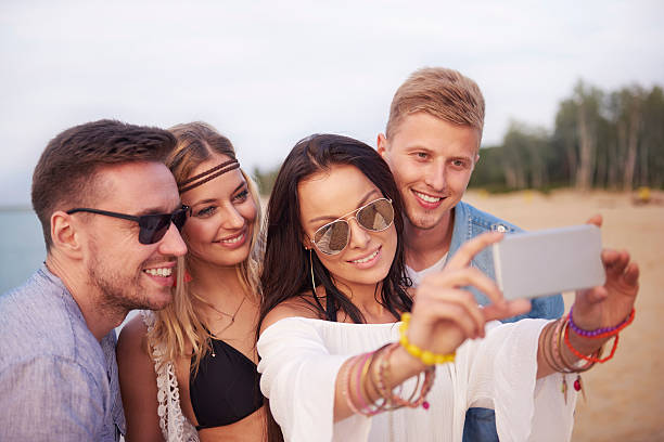 istock Friends taking selfie on the beach during the sunset 547123810