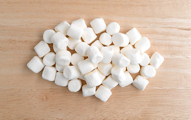 istock Small marshmallows on a wood cutting board 547124074