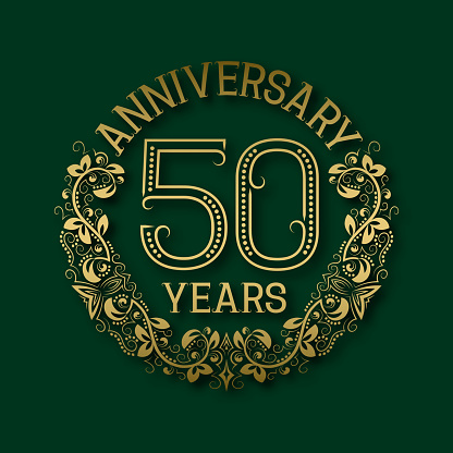 Golden emblem of fiftieth years anniversary. Celebration patterned insignia with shadow on green.