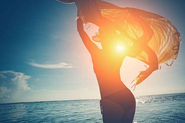 istock Woman with shawl dancing in the ocean 547124766