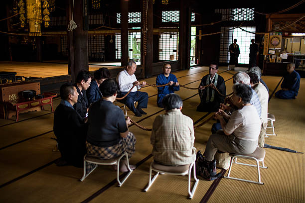 Kyoto, Japan - May 28, 2016: Group of Japanese people praying in a circle at Buddhist Chion-ji Temple in Kyoto.