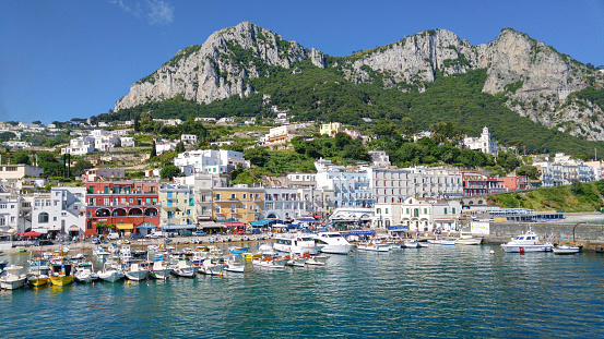 Сapri, Italy - May 31, 2016: Capri Island Landscape, Marina Grande harbour and mountains.