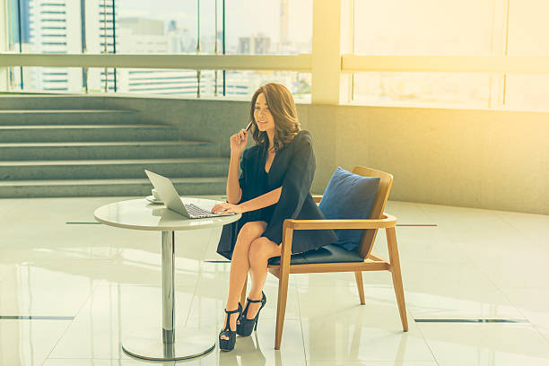 istock Beautiful Young Asian Businesswomen using a laptop computer 547129626