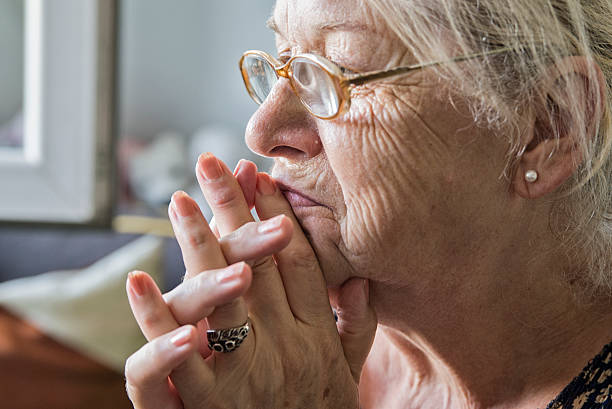 istock Senior woman looking out a window - Memories 547130168