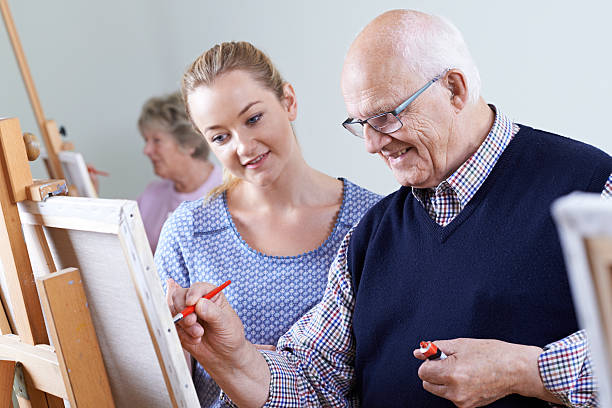 Seniors Attending Painting Class With Teacher